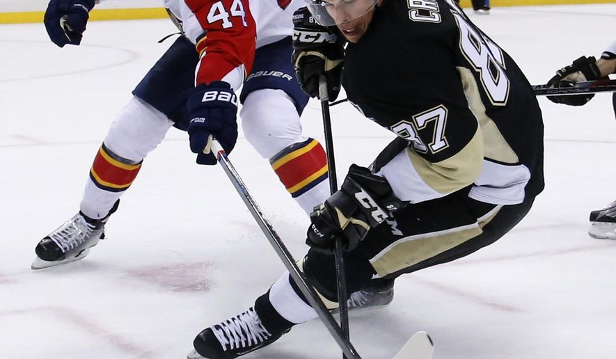 Florida Panthers&#39; Erik Gudbranson (44) knocks the puck off the stick of Pittsburgh Penguins&#39; Sidney Crosby (87) during the second period of an NHL hockey game in Pittsburgh, Tuesday, Oct. 20, 2015. (AP Photo/Gene J. Puskar)