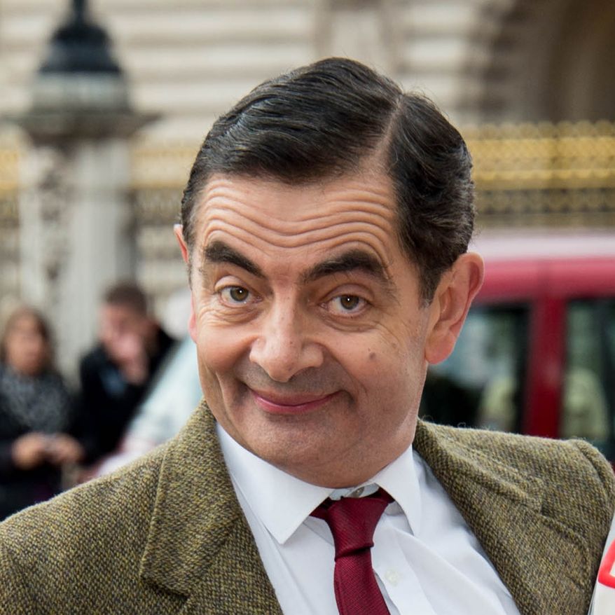 British actor Rowan Atkinson, dressed as Mr Bean poses for photographers outside Buckingham Palace, London, to promote the 25th anniversary of Mr Bean, London, Friday, Sept. 4, 2015. (Photo by Jonathan Short/Invision/AP)