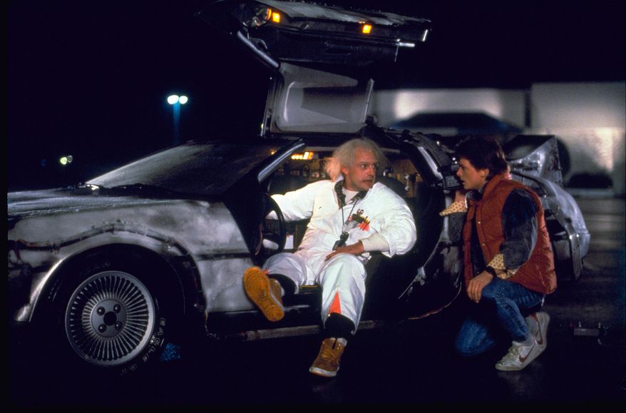 This photo provided by Universal Pictures Home Entertainment shows Christopher Lloyd, left, as Dr. Emmett Brown, and Michael J. Fox as Marty McFly in the 1985 film, "Back to the Future." Wednesday's so-called "Back to the Future" Day marks the date - Oct. 21, 2015 - that characters McFly, Brown and Jennifer Parker famously journeyed to the future in the film trilogy's second installment in 1989. "The Back to the Future 30th Anniversary Trilogy" and "Back to the Future: The Complete Adventures" release on Blu-ray and DVD on Oct. 20. (Universal Pictures Home Entertainment via AP)