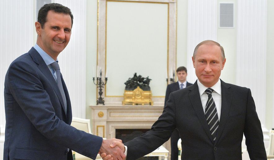 In this photo taken on Tuesday, Oct. 20, 2015, Russian President Vladimir Putin, right, shakes hand with Syria President Bashar Assad in the Kremlin in Moscow, Russia. Assad has traveled to Moscow in his first known trip abroad since the war broke out in Syria in 2011 to meet his strongest ally Russian leader Vladimir Putin, Syrian and Russian media reported Wednesday. (Alexei Druzhinin, RIA-Novosti,  Kremlin Pool Photo via AP)