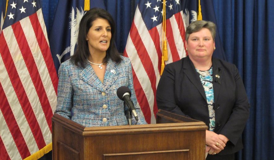 South Carolina Gov. Nikki Haley, left, announces she wants to make interim Department of Transportation Secretary Christy Hall, right, the permanent director of the agency, Wednesday, Oct. 21, 2015, in Columbia, S.C. Both the governor and lawmakers gave Hall high marks for the DOT&#39;s work fixing roads and bridges damaged by massive floods in October 2015. (AP Photo/Jeffrey Collins)