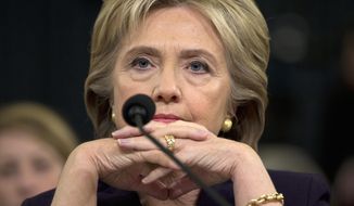 Democratic presidential candidate, former Secretary of State Hillary Rodham Clinton listens as she testifies on Capitol Hill in Washington, Thursday, Oct. 22, 2015, before the House Benghazi Committee. (AP Photo/Evan Vucci)