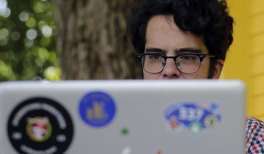 Michael Madden works on his website, Thursday, Sept. 10, 2015, in Austin, Texas. Madden a largely self-taught analyst of North Korea with an encyclopedic knowledge of the government elite, (AP Photo/Eric Gay)