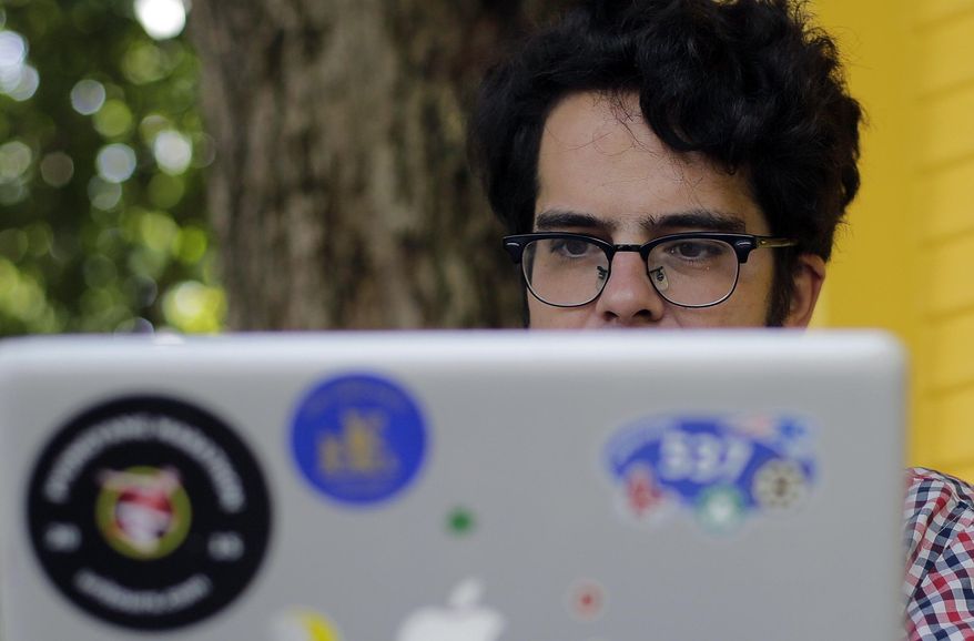 Michael Madden works on his website, Thursday, Sept. 10, 2015, in Austin, Texas. Madden a largely self-taught analyst of North Korea with an encyclopedic knowledge of the government elite, (AP Photo/Eric Gay)