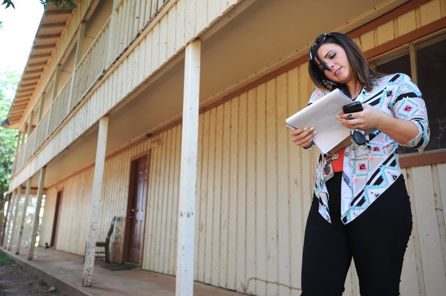 ADVANCE FOR SUNDAY OCT. 25 AND THEREAFTER - In a Wednesday, Aug. 26, 2015 photo, Child Protective Services caseworker Catherine Eberhardt calls to report to her supervisor details from her investigation of a parent accused of using methamphetamine, in Abilene, Texas. Like many Child Protective Services caseworkers, Eberhardt has a background that influences her work.(Nellie Doneva/Abilene Reporter-News via AP)