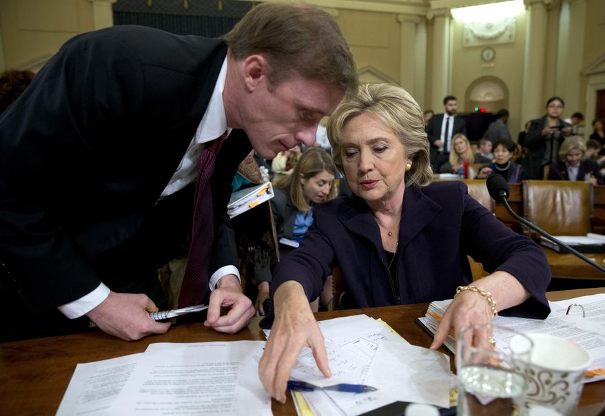Democratic presidential candidate former Secretary of State Hillary Rodham Clinton talks with Jake Sullivan, a former staff member for her at the State Department, during a break in testimony on Capitol Hill in Washington, Thursday, Oct. 22, 2015, before the House Select Committee on Benghazi. (AP Photo/Carolyn Kaster)