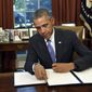 President Barack Obama vetoes the National Defense Authorization Act (NDAA), Thursday, Oct. 22, 2015, in the Oval Office of the White House in Washington. The president vetoed the sweeping $612 billion defense policy bill, citing objections over how the measure is funded. (AP Photo/Susan Walsh)