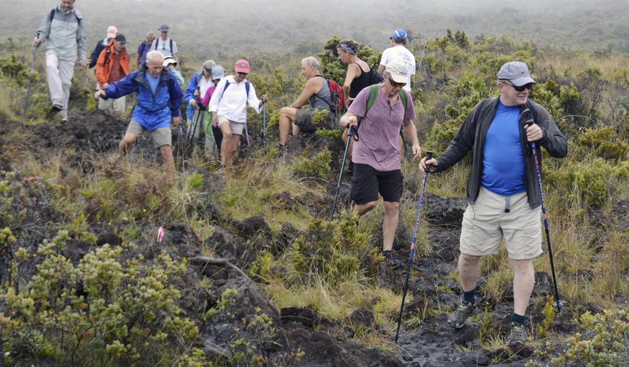 ADVANCE FOR WEEKEND OCT. 24-25 AND THEREAFTER - In this Oct. 11, 2015 photo, a group of 15 hikers, led by the Sierra Club Maui, hike a section of the old Haleakala Trail that had been closed to the public for decades in Haleakala, Hawaii. This trail, that had been the subject of a lawsuit over accessibility, was likely used by Mark Twain and Jack London when they made their treks to the summit of the 10,000 foot Haleakala. (Eileen Chao/The Maui News via AP)