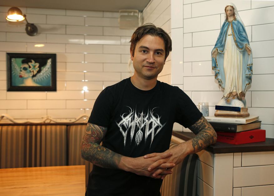 Acclaimed pastry chef Alex Stupak, who shifted over to Mexican food several years ago, poses for a photograph in front of his Mexican restaurant Empellon Cocina, in Manhattan's East Village, Tuesday, Oct. 20, 2015, in New York. Stupak, who worked in kitchens known for molecular gastronomy, has come out with a cookbook that approaches tacos in a whole different way. (AP Photo/Kathy Willens)