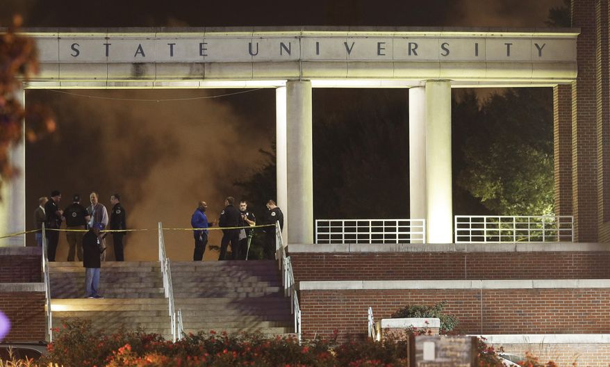 Officials investigate the scene of a shooting on the campus of Tennessee State University, early Friday, Oct. 23, 2015, in Nashville, Tenn. Authorities say one person was killed and three others wounded in the Thursday shooting at an outdoor courtyard. A campus representative said the person killed wasn't enrolled at the school. (AP Photo/Mark Humphrey)