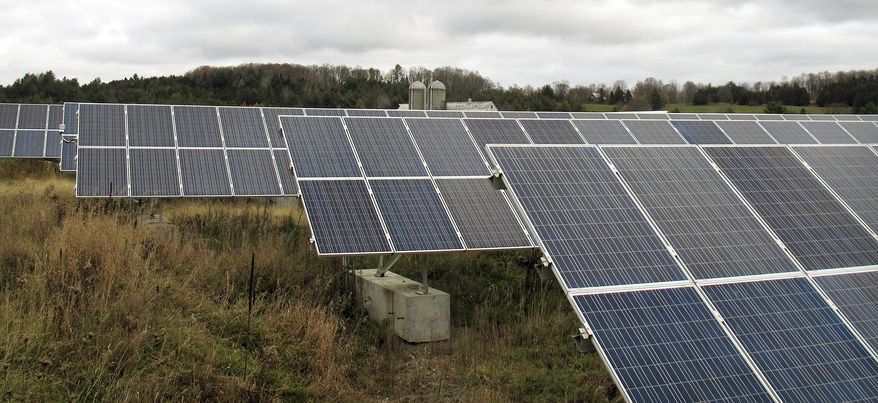In this Friday Oct. 23, 2015 photo, solar panels that are part of a 100-kilowatt net metered project stand in a field on the McKnight Farm in East Montpelier, Vt. In 2014 Gov. Peter Shumlin signed a law at the farm which more than tripled the amount amount of electricity that can be sent to the electric grid from such projects. The amount of electricity being produced in the state by small net metered projects is growing faster than expected, and many utilities are nearing the cap established by the law. (Photo/Wilson Ring)