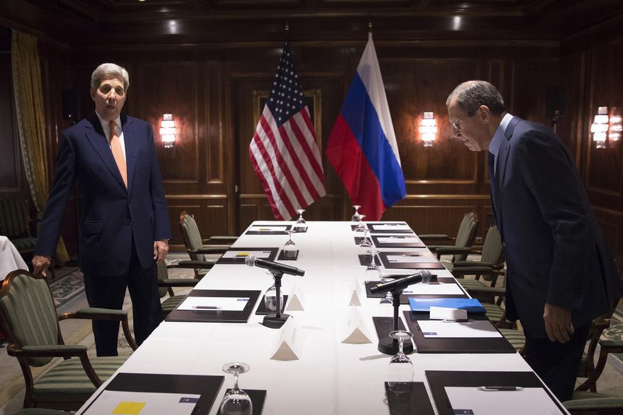 U.S. Secretary of State John Kerry, left, and Russian Foreign Minister Sergey Lavrov take their seats following a photo a photo opportunity in Vienna, Friday, Oct. 23, 2015. Kerry and his Russian, Saudi and Turkish counterparts met in Vienna on Friday, seeking to revive a moribund effort to end Syria's civil war. (Carlo Allegri/Pool Photo via AP)
