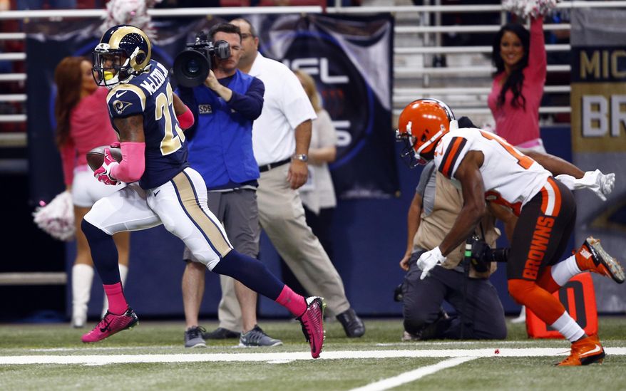 St. Louis Rams free safety Rodney McLeod, left, runs past Cleveland Browns wide receiver Taylor Gabriel after recovering a fumble by Gabriel and running it back for a touchdown during the first quarter of an NFL football game Sunday, Oct. 25, 2015, in St. Louis. (AP Photo/Billy Hurst)