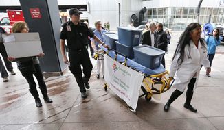 Colorado state Sen. Irene Aguilar (right), a Democrat and a physician, helps deliver more than 156,000 signatures to put a health care question on next year&#x27;s general election ballot. ColoradoCareYES wants to start the nation&#x27;s first universal health care plan. (Associated press)