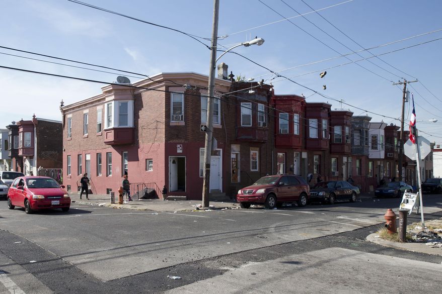In this Wednesday, Oct. 21, 2015, photo, the intersection of Marshall and Tioga streets in Philadelphia is shown. Drug kingpin Myrna Suren ran a $100,000-a-week cocaine ring centered around this corner in Philadelphia&#39;s Hunting Park neighborhood in the 1980s, but is leaving prison soon after her life sentence was cut to 25 years under revised U.S. drug policies. She is one of 6,000 drug offenders leaving prison early this year. (AP Photo/Matt Rourke)