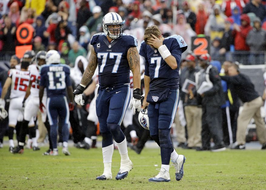 Tennessee Titans quarterback Zach Mettenberger (7) and tackle Taylor Lewan (77) walk to the sideline after the Atlanta Falcons&#39; Robenson Therezie intercepted a pass to stop the Titans&#39; final drive of the game in the fourth quarter of an NFL football game Sunday, Oct. 25, 2015, in Nashville, Tenn. The Falcons won 10-7. (AP Photo/James Kenney)