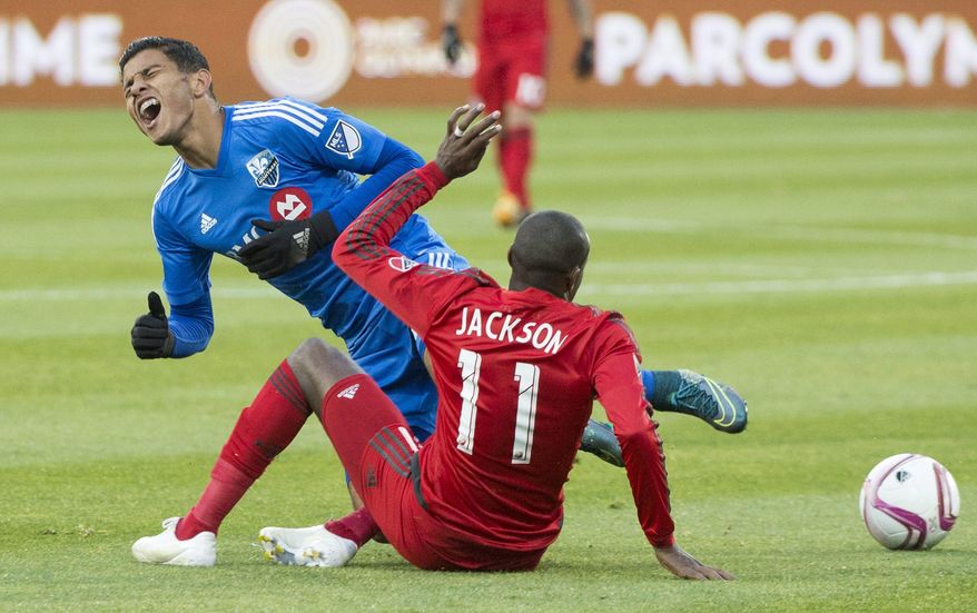 Montreal Impact&#39;s Johan Venegas, left, challenges Toronto FC&#39;s Jackson during first half MLS soccer action in Montreal, Sunday, Oct. 25, 2015. (Graham Hughes/The Canadian Press via AP)