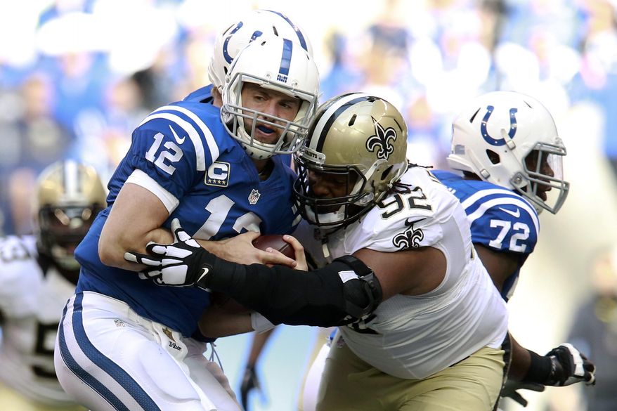 Indianapolis Colts quarterback Andrew Luck (12) is sacked by New Orleans Saints defensive tackle John Jenkins (92) in the second half of an NFL football game in Indianapolis, Sunday, Oct. 25, 2015. (AP Photo/R Brent Smith)