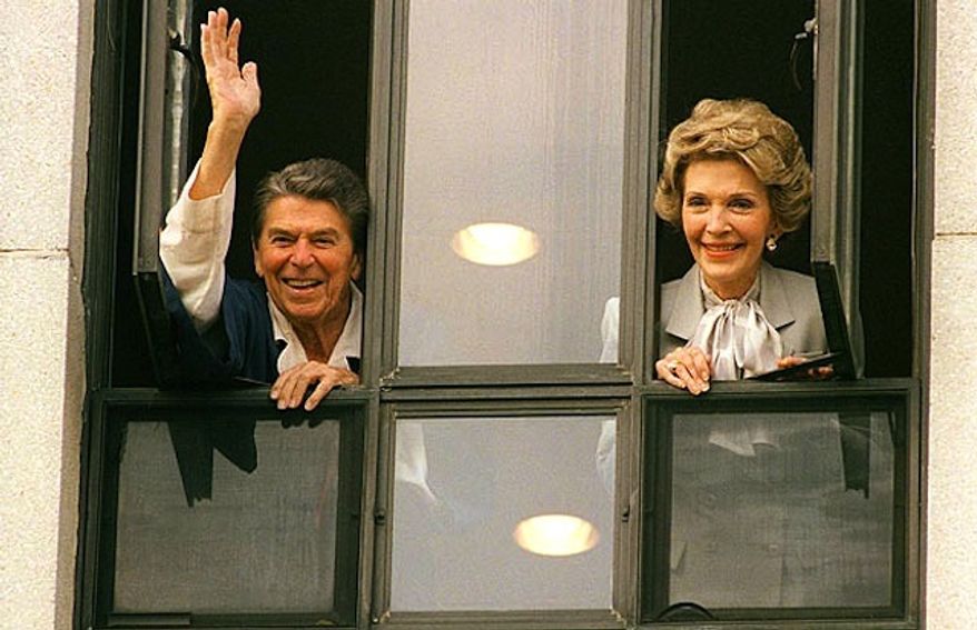 Ronald Reagan and wife Nancy appear at a hospital window to reassure the nation the president was on the mend following a 1981 assassination attempt (AP Photo)