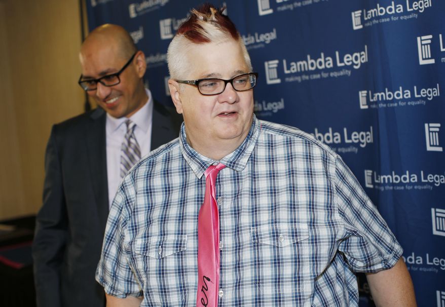 Dana Zzyym, right, the plaintiff in a federal discrimination lawsuit filed by Lambda Legal against the U.S. State Department seeking more gender options for passports, is followed by Paul D. Castillo, staff attorney in the South Central Regional Office of Lambda Legal in Dallas, after a news conference about the case Monday, Oct. 26, 2015, in Denver. Zzyym, an intersex person, was denied a U.S. passport for refusing to check either male or female on the application form. (AP Photo/David Zalubowski)