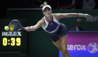 Garbine Muguruza of Spain makes a forehand return against Lucie Safarova of the Czech Republic during their singles match at the WTA tennis finals in Singapore on Monday, Oct. 26, 2015. (AP Photo/Wong Maye-E)