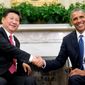FILE - In this Sept. 25, 2015, file photo, U.S. President Barack Obama poses with Chinese President Xi Jinping for a photo during their meeting in the Oval Office of the White House in Washington, following a state arrival ceremony on the South Lawn. In the sometimes-testy rivalry between Washington and Beijing, good manners count. A recent amendment to a U.S.-China accord on safe encounters between their military pilots calls for keeping a secure distance, communicating clearly and keeping a lid on rude body language. The stipulation shows the degree to which the two sides hope to avoid unintended events, although there’s no evidence that insulting behavior has been a factor in any recent encounters. (AP Photo/Andrew Harnik, File)