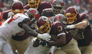 Washington Redskins running back Alfred Morris (46) is stopped by the Tampa Bay Buccaneers defense during the first half of an NFL football game in Landover, Md., Sunday, Oct. 25, 2015. (AP Photo/Alex Brandon)
