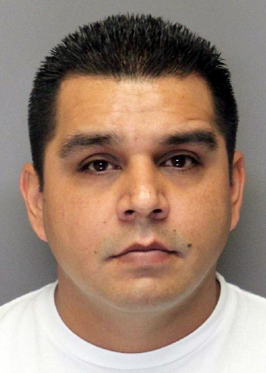 ADVANCE FOR USE ON SUNDAY NOV. 1 - Former West Sacramento police officer Sergio Alvarez is seen in this booking photo provided by the Yolo County Sheriff's Department and taken Monday, Feb. 25, 2013, at the Monroe Detention Center in Woodland, Calif. Alvarez was convicted last year of kidnapping and raping several female victims while he was on overnight patrol duty. (Yolo County Jail via AP)