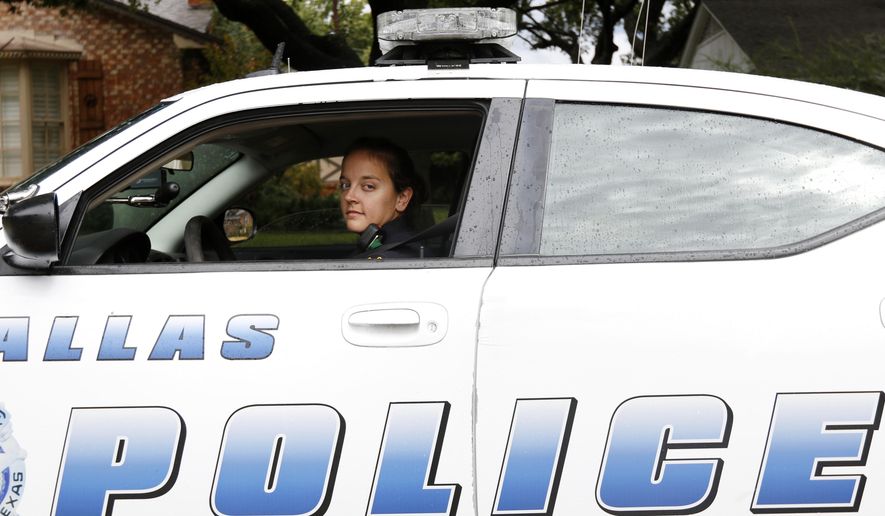 In this Oct. 23, 2015, photo, Dallas Police Senior Corporal Stephanie DeTamble poses for a photo in Dallas. DeTamble was not on patrol at the time the photo was taken. Dallas' wealthier neighborhoods increasingly are funding private patrols staffed by off-duty officers. (Rachel Woolf/The Dallas Morning News via AP) MANDATORY CREDIT; MAGS OUT; TV OUT; INTERNET USE BY AP MEMBERS ONLY; NO SALES