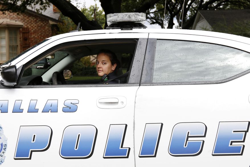 In this Oct. 23, 2015, photo, Dallas Police Senior Corporal Stephanie DeTamble poses for a photo in Dallas. DeTamble was not on patrol at the time the photo was taken. Dallas' wealthier neighborhoods increasingly are funding private patrols staffed by off-duty officers. (Rachel Woolf/The Dallas Morning News via AP) MANDATORY CREDIT; MAGS OUT; TV OUT; INTERNET USE BY AP MEMBERS ONLY; NO SALES