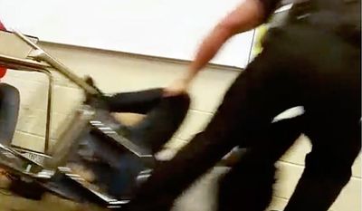 In this Monday, Oct. 26, 2015 photo made from video taken by a Spring Valley High School student, Senior Deputy Ben Fields drags a student across the floor as he removes her from her chair after she refused to leave her high school math class, in Columbia S.C. (AP Photo) ** FILE **