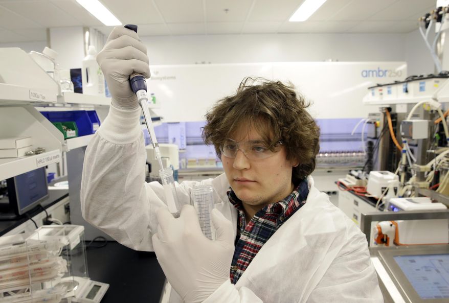 FILE - In this Thursday, Dec. 18, 2014 file photo, scientist William Napoli draws a substance for an experiment in a laboratory at the Merck company facilities in Kenilworth, N.J. Merck reports quarterly financial results on Tuesday, Oct. 27, 2015. (AP Photo/Mel Evans, File)
