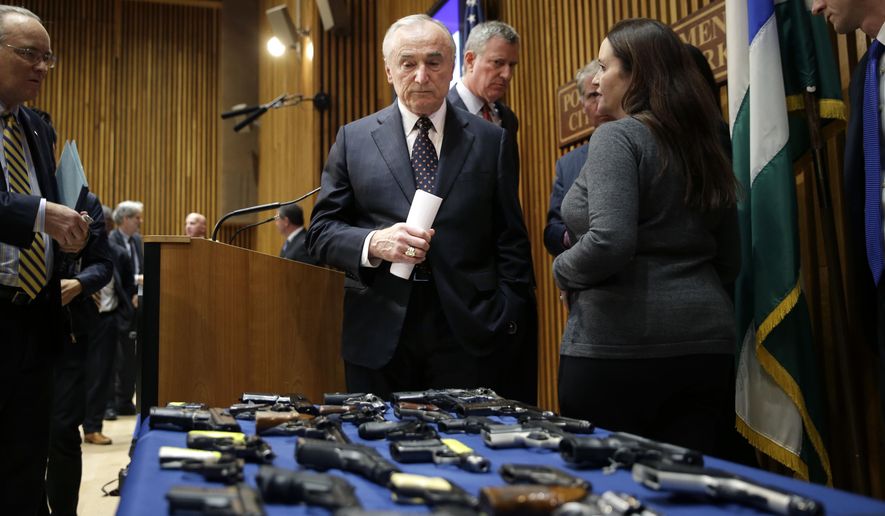 New York City Police Commissioner William Bratton looks at a display of seized guns as he leaves a news conference in New York, Tuesday, Oct. 27, 2015. Officials announced charges in a gun trafficking case where more than 70 firearms were seized. (AP Photo/Seth Wenig) ** FILE **