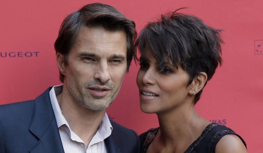 In this June 13, 2013, file photo, actor and president of the Champs-Elysees Film Festival, Olivier Martinez, left, poses with actress Halle Berry prior to the screening of the film "Things We Lost in the Fire" with the french title "Nos Souvenirs Brules" during the Champs-Elysees Film Festival, at the "Publicis Cinema" in Paris. Court records in Los Angeles show Martinez filed for divorce Tuesday, Oct. 27, 2015, citing irreconcilable differences as the cause of the breakup of the actors’ two-year marriage. (AP Photo/Francois Mori, File)