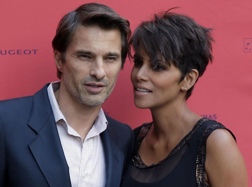 In this June 13, 2013, file photo, actor and president of the Champs-Elysees Film Festival, Olivier Martinez, left, poses with actress Halle Berry prior to the screening of the film "Things We Lost in the Fire" with the french title "Nos Souvenirs Brules" during the Champs-Elysees Film Festival, at the "Publicis Cinema" in Paris. Court records in Los Angeles show Martinez filed for divorce Tuesday, Oct. 27, 2015, citing irreconcilable differences as the cause of the breakup of the actors’ two-year marriage. (AP Photo/Francois Mori, File)
