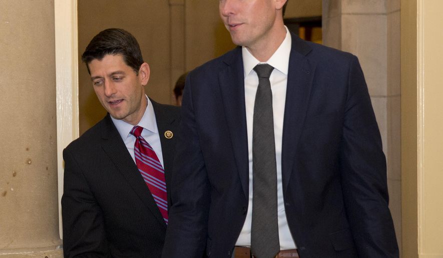 Rep. Paul Ryan, left, walks from a hallway near House Speaker John Boehner of Ohio&#39;s office on Capitol Hill in Washington, Monday, Oct. 26, 2015. Speaker John Boehner is pressing ahead with one last deal as he heads for the exits, pushing to finalize a far-reaching, two-year budget agreement with President Barack Obama before handing Congress&#39; top job over to Ryan this week, congressional officials said Monday.(AP Photo/Carolyn Kaster)