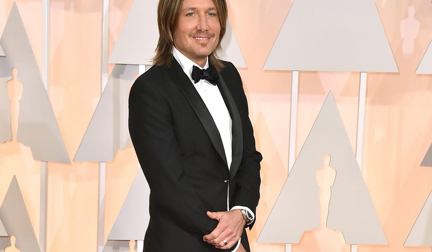 FILE - In this Feb. 22, 2015 file photo, Keith Urban arrives at the Oscars in Los Angeles. Urban’s path from Australia to Music City will be the focus of a new exhibit at the Country Music Hall of Fame and Museum. The exhibit, called “Keith Urban So Far,” will open on Nov. 20 and will show the history of one of country’s biggest global ambassadors through his memorabilia, instruments and documents from his childhood. (Photo by Jordan Strauss/Invision/AP, File)