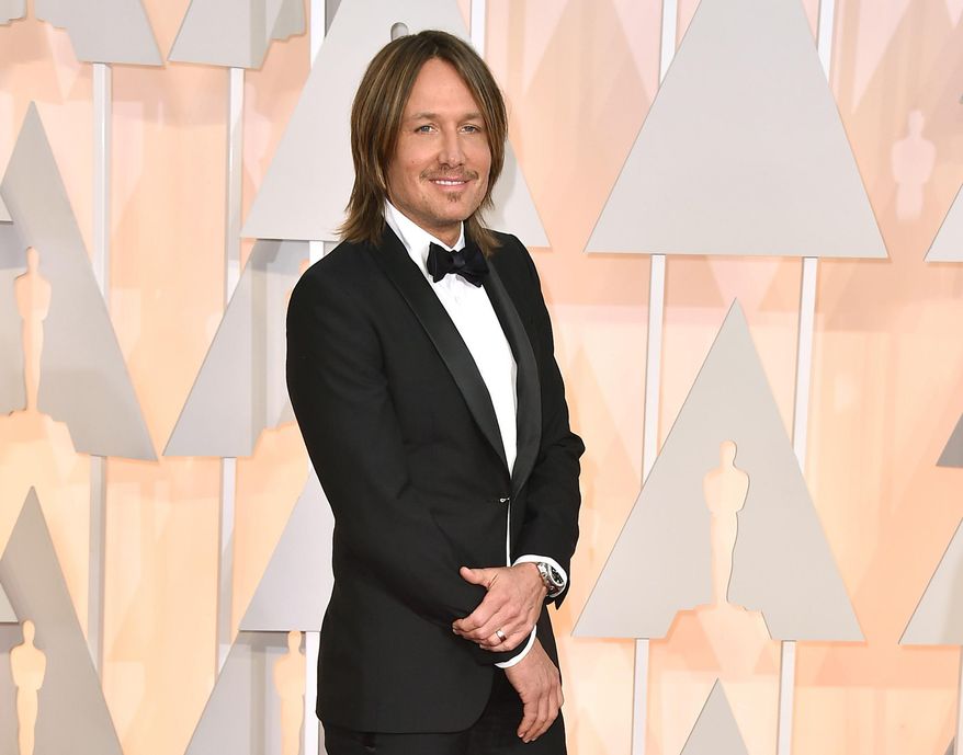 FILE - In this Feb. 22, 2015 file photo, Keith Urban arrives at the Oscars in Los Angeles. Urban’s path from Australia to Music City will be the focus of a new exhibit at the Country Music Hall of Fame and Museum. The exhibit, called “Keith Urban So Far,” will open on Nov. 20 and will show the history of one of country’s biggest global ambassadors through his memorabilia, instruments and documents from his childhood. (Photo by Jordan Strauss/Invision/AP, File)