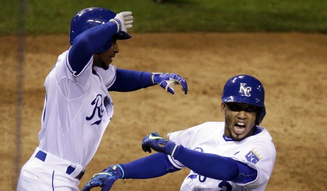 Kansas City Royals&#x27; Alcides Escobar celebrates after scoring the game-winning run during the 14th inning of Game 1 of the Major League Baseball World Series against the New York Mets Wednesday, Oct. 28, 2015, in Kansas City, Mo. The Royals won 5-4 to take a 1-0 lead in the series. (AP Photo/David Goldman)