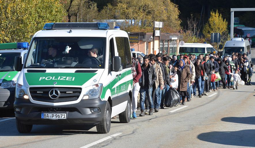 German federal police guide a group of migrants on their way after crossing the border between Austria and Germany in Wegscheid near Passau, Wednesday, Oct. 28, 2015. (AP Photo/Kerstin Joensson) ** FILE **