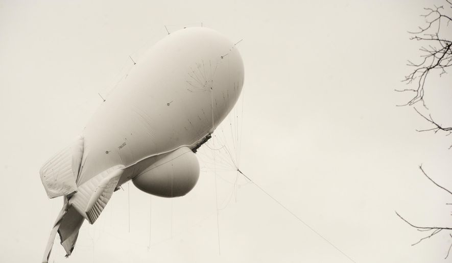 In this file photo, an unmanned Army surveillance blimp floats through the air while dragging a tether line just south of Millville, Pa., Wednesday, Oct. 28, 2015. The Pentagon will spend millions of dollars on a fleet of high-tech surveillance blimps to help control the flow of narcotics and illegal immigrants along the border with Mexico. (Jimmy May/Bloomsburg Press Enterprise via AP)  **FILE**