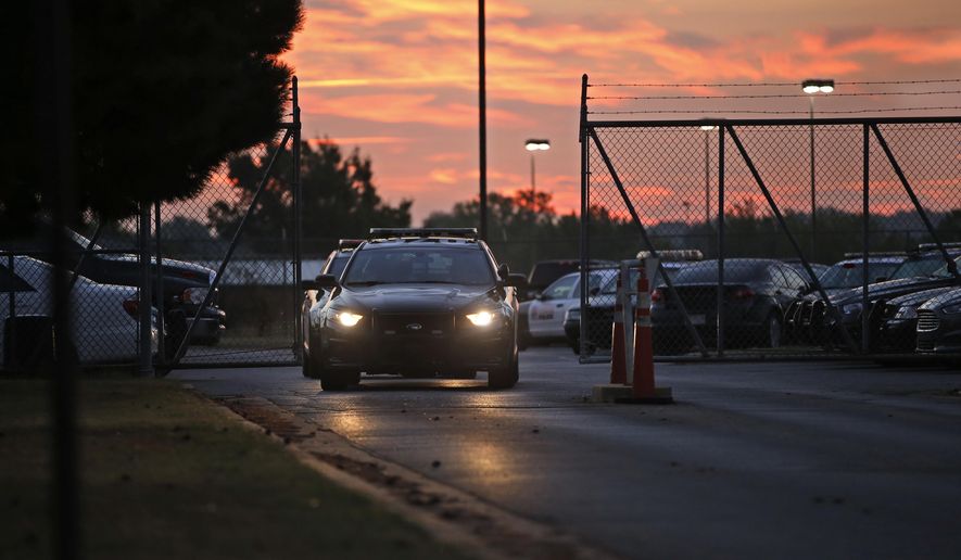 ADVANCE FOR USE TUESDAY, NOV. 3 - Police cars drive out of the Springlake Police Station at shift change in Oklahoma City on Oct. 7, 2015. A yearlong Associated Press investigation into sex abuse by cops, jail guards, deputies and other state law enforcement officials uncovered a broken system for policing bad officers, with significant flaws in how agencies deal with those suspected of sexual misconduct and glaring warning signs that go unreported or get overlooked. (AP Photo/Sue Ogrocki)