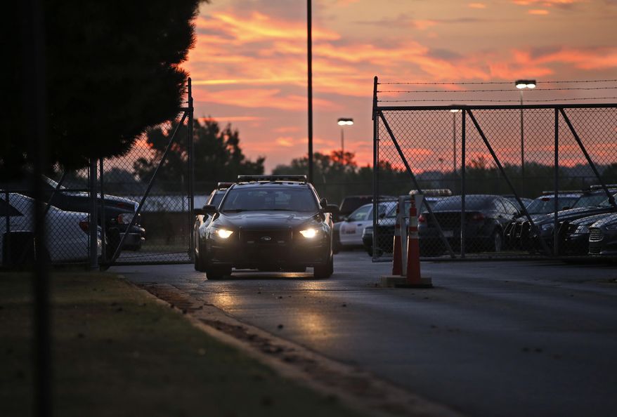 ADVANCE FOR USE TUESDAY, NOV. 3 - Police cars drive out of the Springlake Police Station at shift change in Oklahoma City on Oct. 7, 2015. A yearlong Associated Press investigation into sex abuse by cops, jail guards, deputies and other state law enforcement officials uncovered a broken system for policing bad officers, with significant flaws in how agencies deal with those suspected of sexual misconduct and glaring warning signs that go unreported or get overlooked. (AP Photo/Sue Ogrocki)