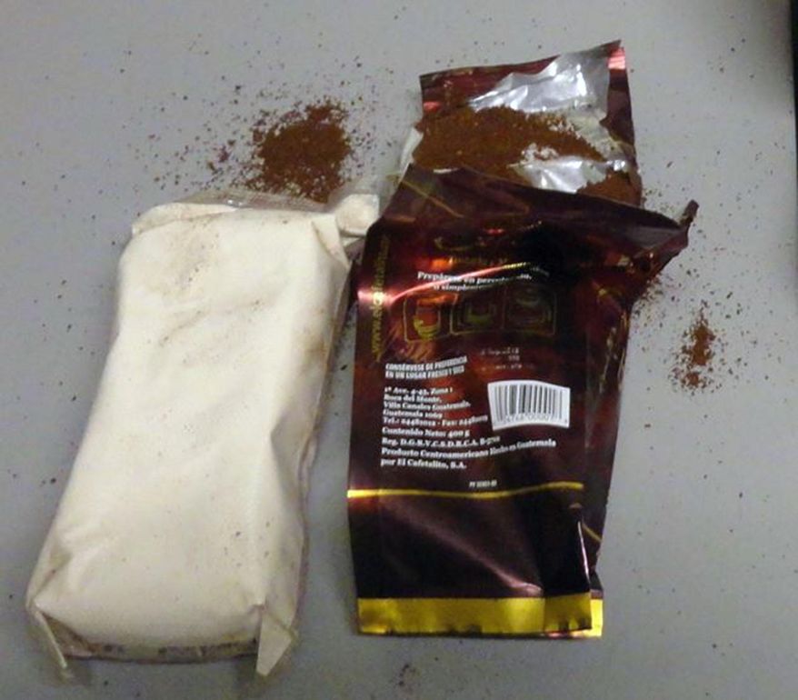 This October 2015 photo provided by U.S. Customs and Border Protection shows a packet of cocaine hidden in a bag of ground coffee in Miami. Three bags of roasted, ground coffee arriving at Miami International Airport in a package from Guatemala in October were actually filled with more than 3 pounds of heroin, customs officials said. Customs officials said they noticed anomalies during an X-ray and felt that the weight of the three bags was different from that of others in the shipment. (U.S. Customs and Border Protection via AP)