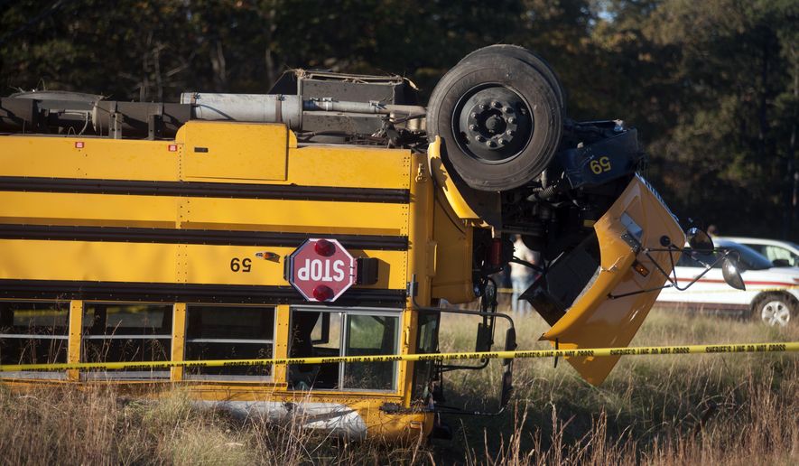 Caroline County Public Schools bus #59 lies overturned after colliding with a minivan near Caroline High School in Caroline County, Va., on Friday, Oct. 30, 2015. Over two dozen students were injured in the accident. (Sarah Ann Jump /The Free Lance-Star via AP) MANDATORY CREDIT