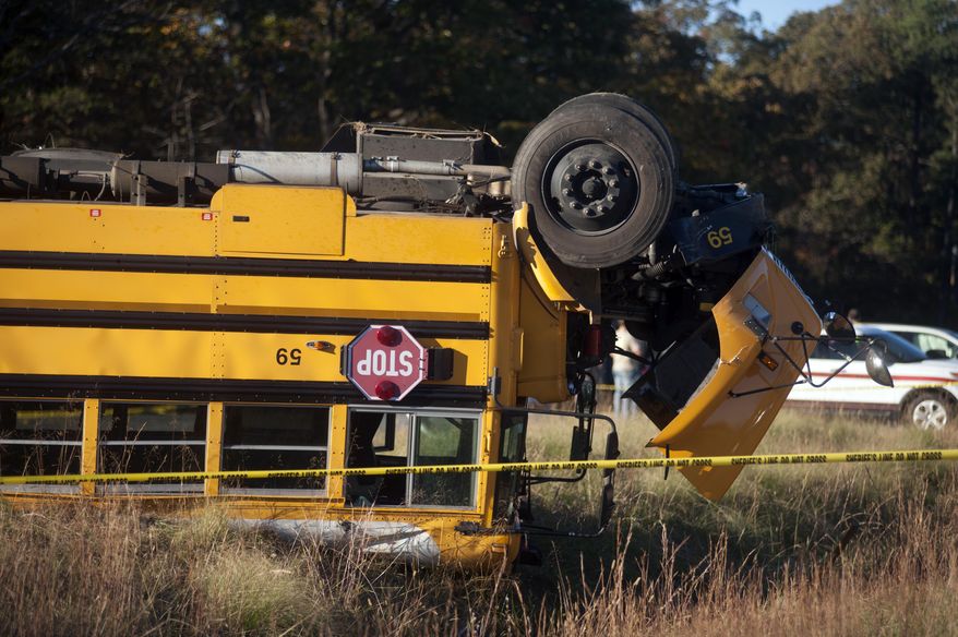 Caroline County Public Schools bus #59 lies overturned after colliding with a minivan near Caroline High School in Caroline County, Va., on Friday, Oct. 30, 2015. Over two dozen students were injured in the accident. (Sarah Ann Jump /The Free Lance-Star via AP) MANDATORY CREDIT