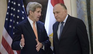 U.S. Secretary of State John Kerry, left, and Egyptian Foreign Minister Sameh Shoukry share a word prior to talks on Syria at a hotel in Vienna, Austria, Friday, Oct. 30, 2015. (Brendan Smialowski/Pool Photo via AP)