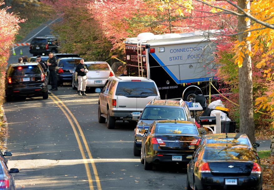 State Police search the area around a home in Weston, Conn., on Friday, Oct. 30, 2015, reportedly belonging to a friend of Kyle Navin. Possible human remains were found during the search and may be linked to the disappearance of missing Easton couple, Jeanette and Jeffery Navin, Kyle Navin's parents. (Cathy Zuraw /Hearst Connecticut Media via AP)