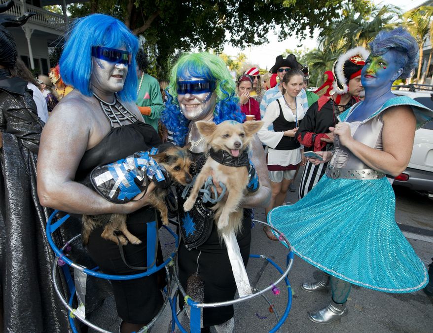 In this Friday, Oct. 30, 2015, photo provided by the Florida Keys News Bureau, people and their dogs dresses as space creatures proceed down Fleming Street in Key West, Fla., during the Fantasy Fest Masquerade March. Thousands participated in the event that was one of the highlights of the subtropical island&#39;s annual Fantasy Fest costuming and masking festival that is to conclude Sunday, Nov. 1. This year&#39;s festival theme is &amp;quot;All Hallows Intergalactic Freak Show.&amp;quot; (Andy Newman/Florida Keys News Bureau via AP)