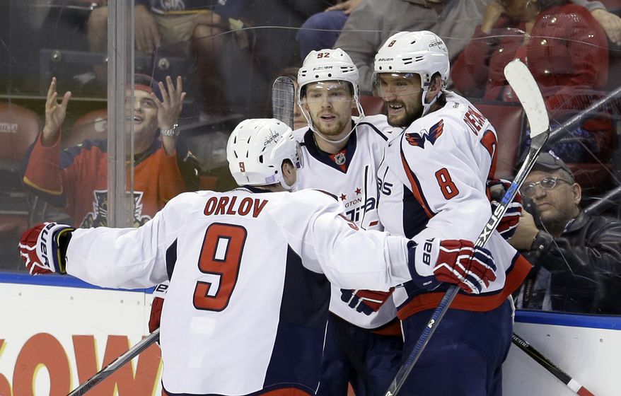Washington Capitals defenseman Dmitry Orlov (9) and Alex Ovechkin (8) congratulate Evgeny Kuznetsov (92) after Kuznetsov scored the game-winning, 2-1, goal against the Florida Panthers in overtime of an NHL hockey game, Saturday, Oct. 31, 2015, in Sunrise, Fla. (AP Photo/Alan Diaz)